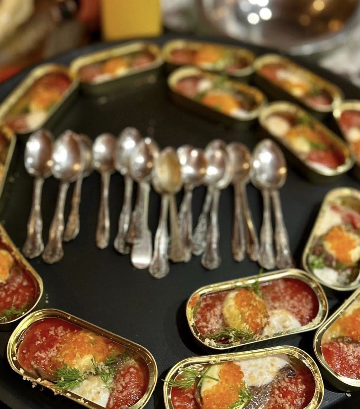 Tinned fish appetizers with caviar, arranged on a tray