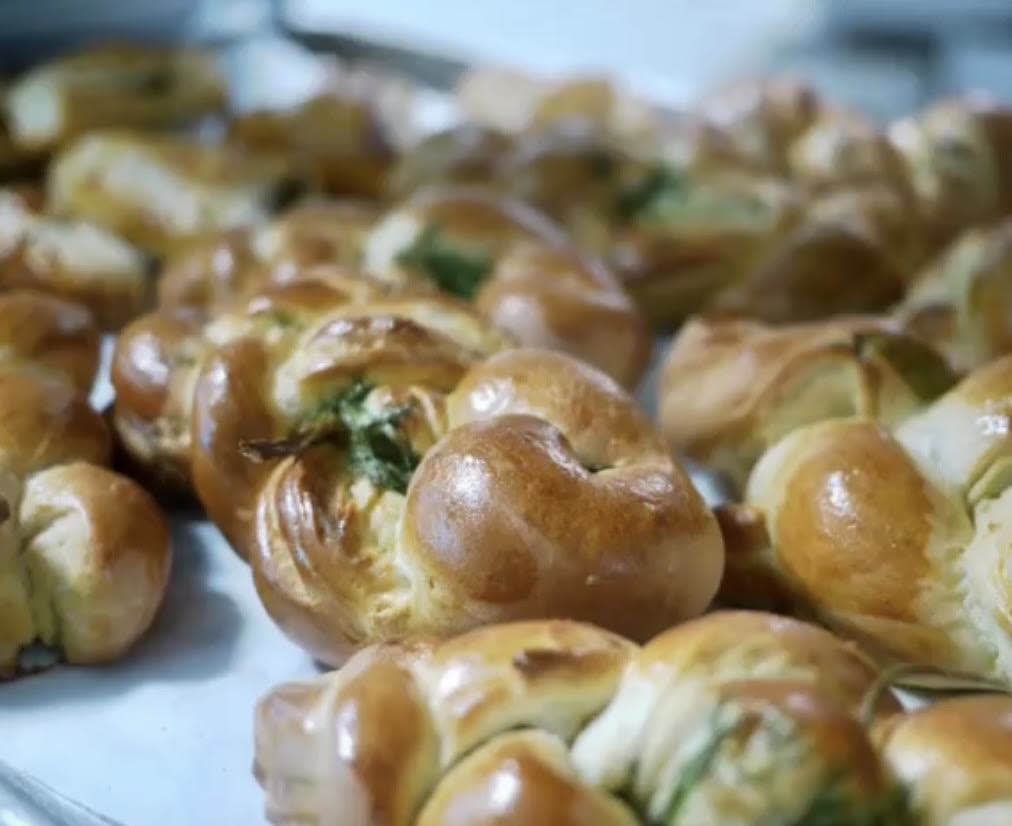 Fresh baked pastry knots on a sheet tray
