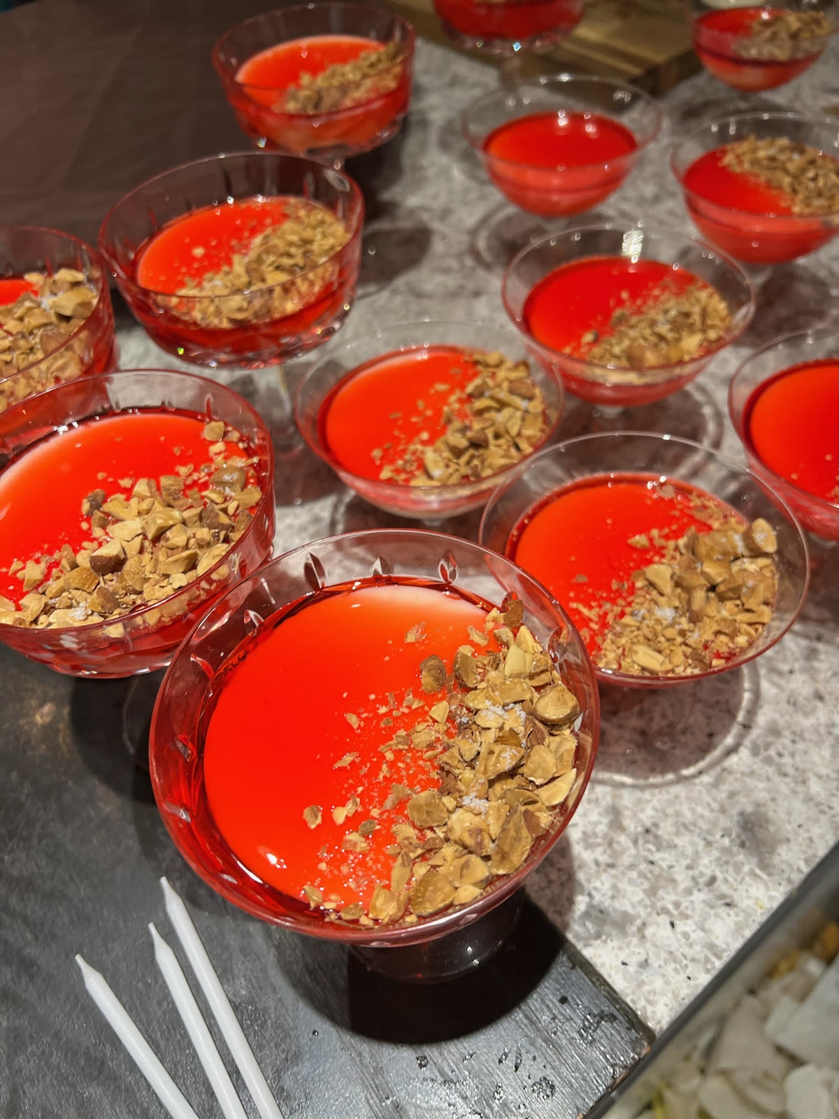 Red gelee desserts topped with chopped almonds