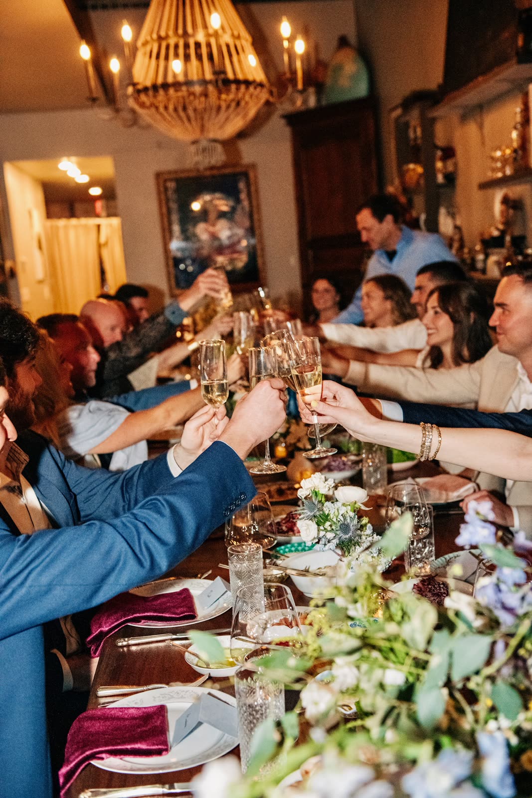 Guests raising a champagne toast at the table