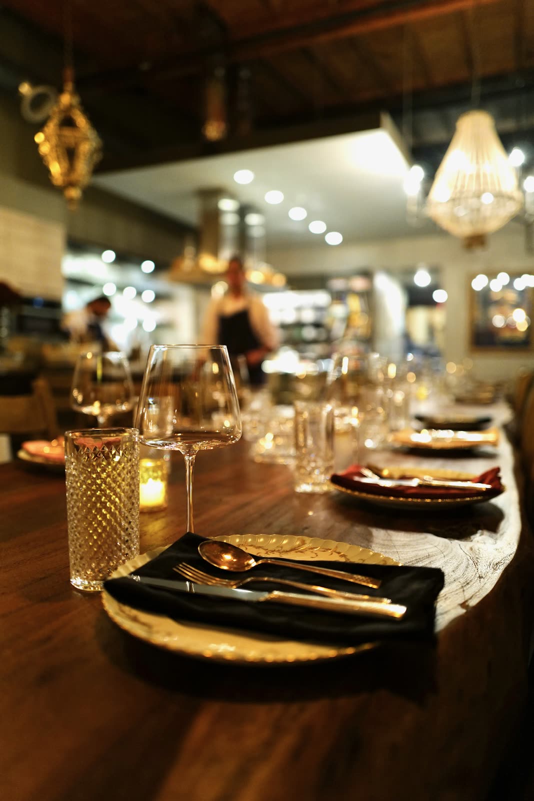 Table set with fine glassware, the open kitchen in the background