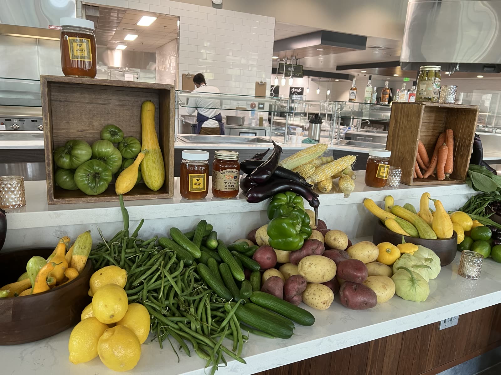 Farm produce display at the counter with sunflowers